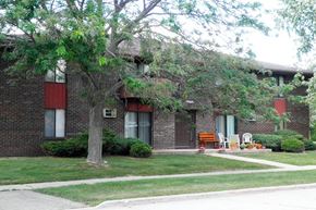 Appleton apartment for rent - a brick house with a tree in front of it