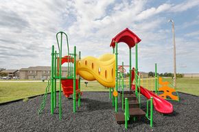 Newton apartment for rent - a playground with a yellow and red swing set