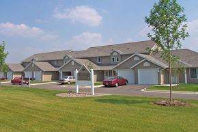 Kasson apartment for rent - a large building with cars parked in front of it