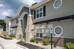 Knightstown apartment for rent - A modern house with a stone pillar and a sign indicating a handicapped parking spot.