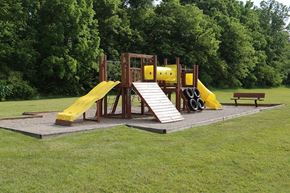 Sidney apartment for rent - A playground with a yellow slide and a wooden structure.