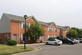 Florence apartment for rent - a brick building with cars parked in a parking lot