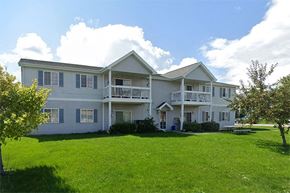 Sturgeon Bay apartment for rent - a large house with a yard in front of it