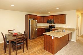 Jackson apartment for rent - a kitchen with stainless steel appliances and a table