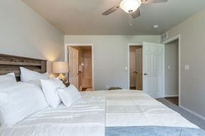 Union Grove apartment for rent - A bedroom with a large bed and a ceiling fan.