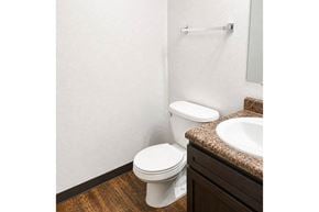Northfield apartment for rent - A white toilet sits next to a sink in a small bathroom.
