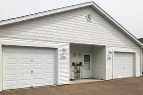 Ladysmith apartment for rent - a white building with two white garage doors