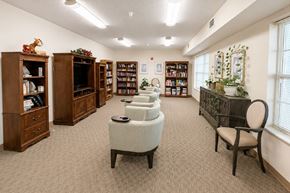 Creston apartment for rent - A room with a carpeted floor and a collection of bookcases filled with books.