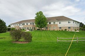 Muskego apartment for rent - A large house with a green lawn in front.