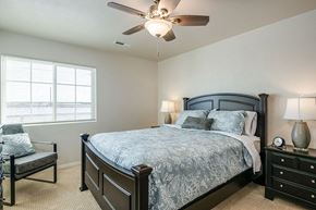 Harrison apartment for rent - a bedroom with a bed and a ceiling fan