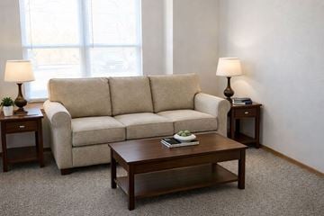 Marshalltown apartment for rent - A beige couch sits in a living room with a coffee table in front of it.