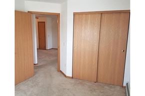 Hartford apartment for rent - a bedroom with a closet and a door to a hallway