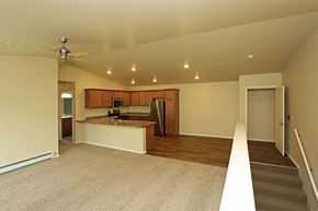 Lomira apartment for rent - an empty living room with a kitchen and