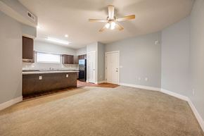 Rushville apartment for rent - A spacious room with a ceiling fan and carpeted floor.