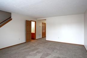 Florence apartment for rent - an empty living room with white walls and carpet