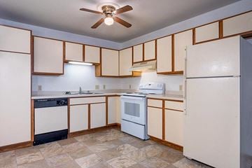 Stevens Point apartment for rent - A kitchen with white appliances and wooden cabinets.