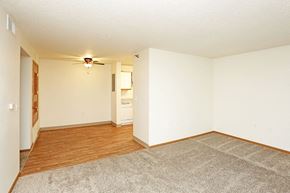 Grinnell apartment for rent - A room with a ceiling fan and a rug on the floor.