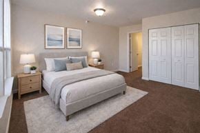 Winfield apartment for rent - A bedroom with a large bed and two lamps.