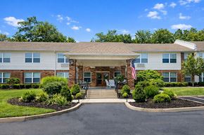 Nicholasville apartment for rent - A building with a flag on the front and a driveway leading to the entrance.