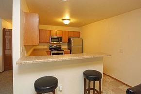 Greenville apartment for rent - a kitchen with a counter with two bar stools