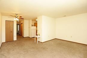 Gaylord apartment for rent - an empty living room with a ceiling fan