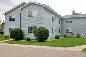 Waseca apartment for rent - a blue house with a lawn in front of it
