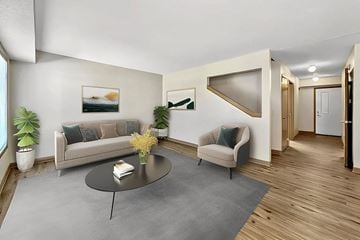 Waukee apartment for rent - A living room with a grey sofa and a grey coffee table.