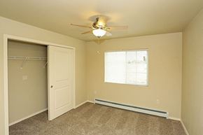 Lomira apartment for rent - an empty bedroom with a ceiling fan and a closet