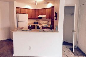 Hurricane apartment for rent - a kitchen with a counter and a refrigerator