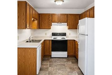 Fond Du Lac apartment for rent - A kitchen with wooden cabinets and a white refrigerator.
