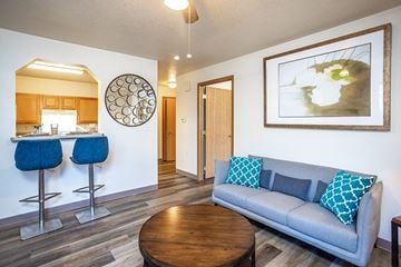 Waukee apartment for rent - A living room with a grey couch and a wooden coffee table.
