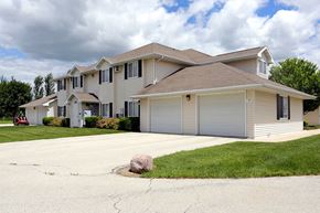 Green Bay apartment for rent - A house with a grey roof and a driveway with a rock in it.