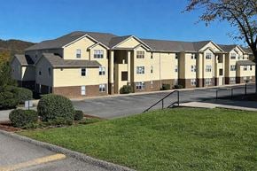 Winfield apartment for rent - A large apartment complex with a parking lot in front.