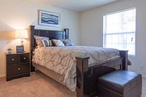 Liberal apartment for rent - a bedroom with a large bed and a window