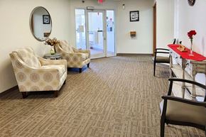 Clinton apartment for rent - A waiting room with two chairs and a table with a vase of flowers on it.