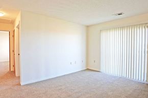 Kenton apartment for rent - an empty living room with a large window and blinds