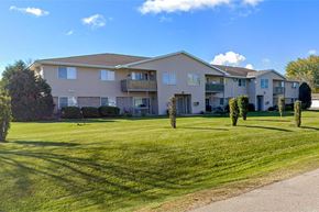 Greenville apartment for rent - Apartment complex with green lawn in front.