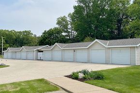 Black River Falls apartment for rent - a row of white garages in a parking lot