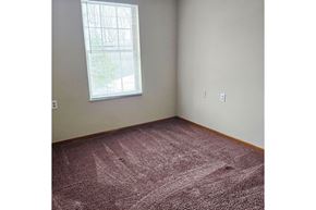 South Charleston apartment for rent - A room with a window and a carpeted floor.