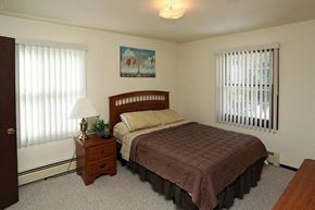 Manitowoc apartment for rent - a bedroom with a bed and two windows