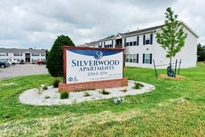 Winfield apartment for rent - A sign for Silverwood Apartments is in front of a building.