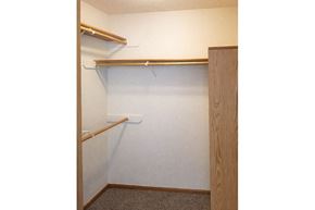 Oskaloosa apartment for rent - A small closet with a white door and a brown shelf.