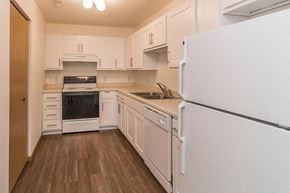 Bismarck apartment for rent - a white kitchen with a stove and a refrigerator