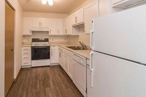 Bismarck apartment for rent - a white kitchen with a stove and a refrigerator