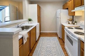 Winfield apartment for rent - A kitchen with white appliances and wooden cabinets.