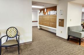 Clinton apartment for rent - A room with a chair, a sofa and a cabinet with drawers.
