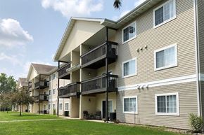 Ottumwa apartment for rent - a building with two balconies and a lawn