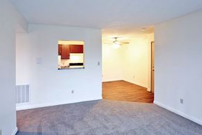 Napoleon apartment for rent - an empty living room with white walls and a kitchen