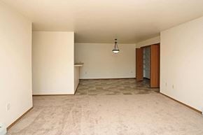 Oshkosh apartment for rent - an empty living room with white walls and a tile floor