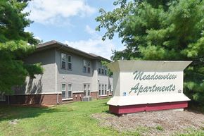 Mahomet apartment for rent - a building with a sign in front of it